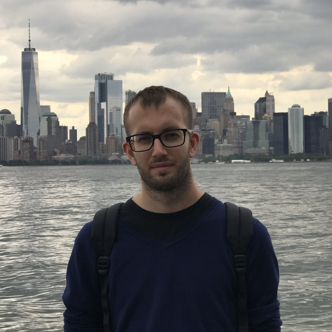 A picture of Mattia with NY skyline as background. He is a blond caucasian male of average height and build